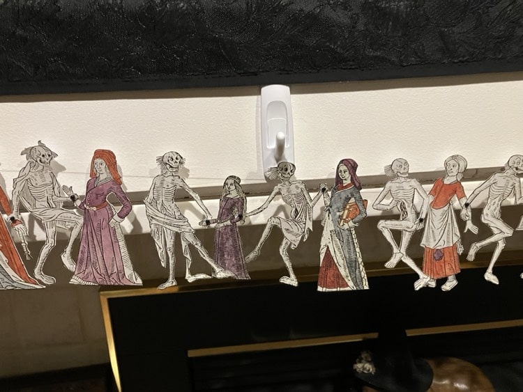 Middle class women, including a young girl and student, dancing with skeletons