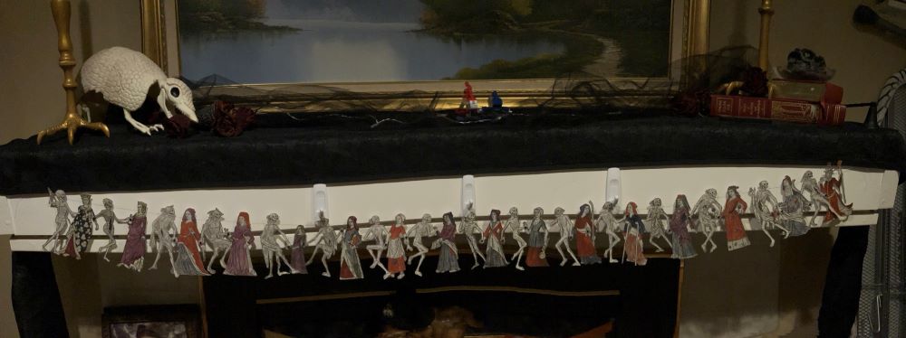 Paper garland depicting medieval women and skeletons dancing