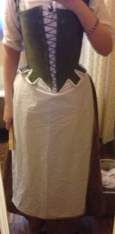 Green bodice over brown skirt with white apron
